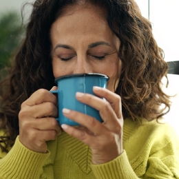 woman sipping from coffee mug